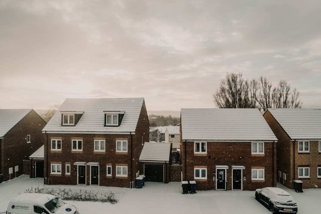 our-story-01 a-couple-of-cars-parked-in-front-of-a-row-of-houses-fw-xmg0aqd8