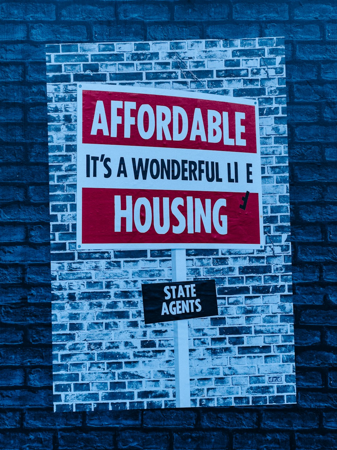 services-02 a-red-and-white-sign-on-a-brick-wall-vdbbwi9urxw