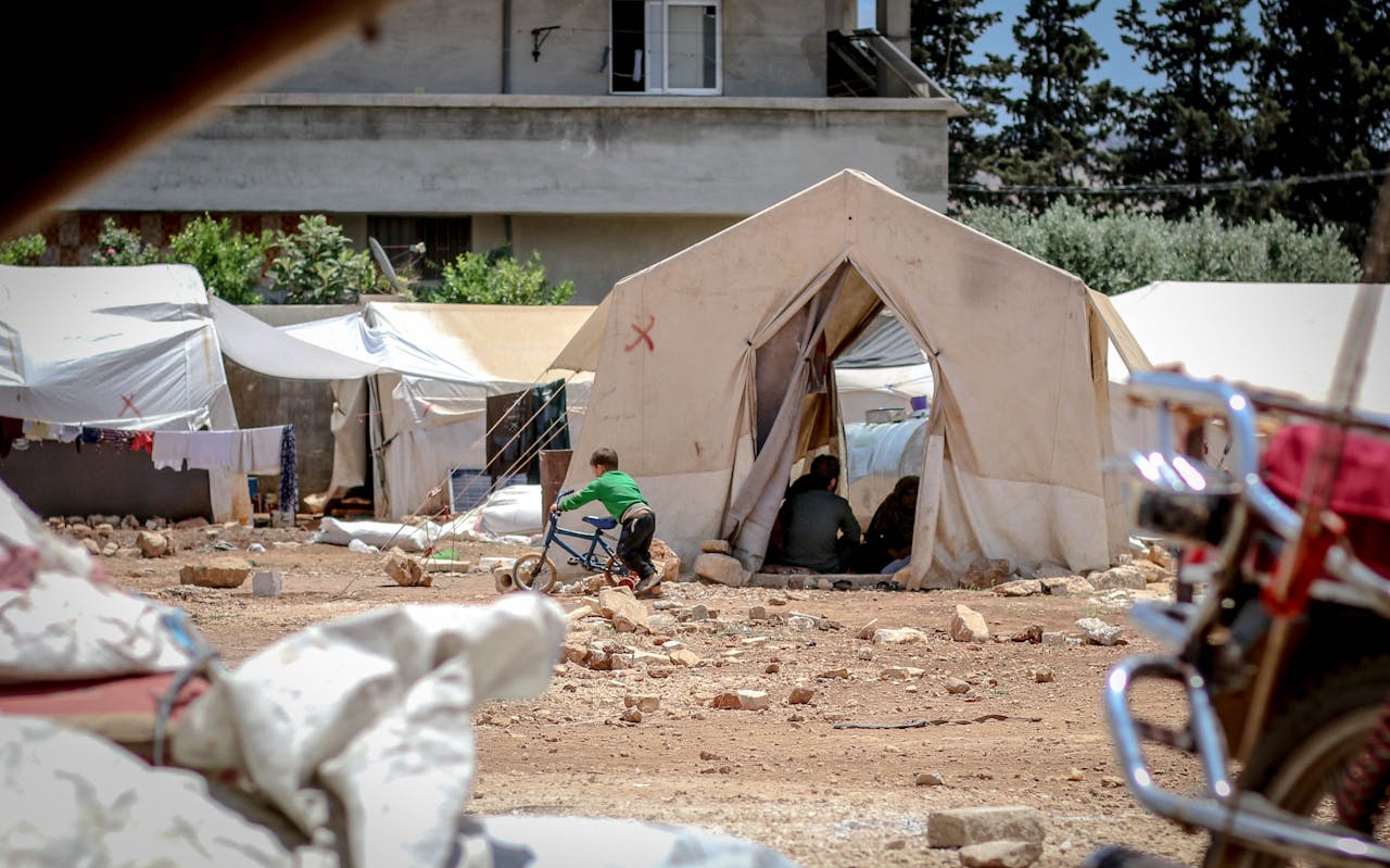 about-01 Temporary fabric tents located on ground with garbage in poor district for refugee camp